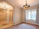 Dining area featuring carpet flooring, a stylish chandelier, and natural light at 15290 W Ventura St, Surprise, AZ 85379