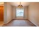Cozy dining area with carpet flooring, a chandelier, and a large window at 15290 W Ventura St, Surprise, AZ 85379