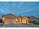 Charming single-story home featuring a three-car garage and well-manicured desert landscaping at 15290 W Ventura St, Surprise, AZ 85379