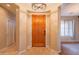 Warm and inviting foyer featuring wood flooring, a decorative chandelier, and neutral paint at 15290 W Ventura St, Surprise, AZ 85379