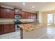 Well-appointed kitchen features granite countertops, ample cabinet space, and stainless steel appliances at 15290 W Ventura St, Surprise, AZ 85379