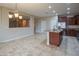 Spacious kitchen features granite countertops, stainless steel appliances, and neutral tile flooring at 15290 W Ventura St, Surprise, AZ 85379