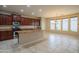 Open kitchen featuring an island with granite countertops, stainless steel appliances, and large windows at 15290 W Ventura St, Surprise, AZ 85379