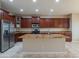 Large kitchen featuring granite countertops, a central island, and stainless steel appliances at 15290 W Ventura St, Surprise, AZ 85379