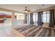 Spacious living room with tile floors, ceiling fan, and sliding doors leading to a backyard at 15290 W Ventura St, Surprise, AZ 85379