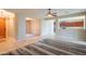 Open living room with tile floors, view to the kitchen, and natural light at 15290 W Ventura St, Surprise, AZ 85379