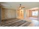Bright living room with tile flooring, ceiling fan, and open access to other rooms at 15290 W Ventura St, Surprise, AZ 85379