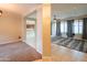 Open-concept living room featuring tile flooring, large windows, and a view of the kitchen at 15290 W Ventura St, Surprise, AZ 85379