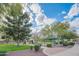 Community park with playground, picnic area, and green space under a bright, partly cloudy sky in a well-maintained area at 15290 W Ventura St, Surprise, AZ 85379