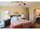 Comfortable bedroom featuring decorative pillows, side tables, and decorative wall hangings at 1534 E Bowman Dr, Casa Grande, AZ 85122