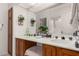 Bathroom featuring double sinks, wood cabinets, a shower over tub, and ample counter space at 16724 E Gunsight Dr # 118, Fountain Hills, AZ 85268