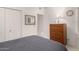 Bedroom with neutral carpet, white walls and a wooden dresser and double mirrored closet doors at 16724 E Gunsight Dr # 118, Fountain Hills, AZ 85268