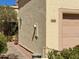 Charming condo exterior with pathway and garage, highlighted by a lantern and desert foliage at 16724 E Gunsight Dr # 118, Fountain Hills, AZ 85268