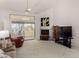 Bright living room boasting a fireplace, access to outdoor patio, and neutral carpet at 16724 E Gunsight Dr # 118, Fountain Hills, AZ 85268