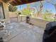 Back patio with white metal furniture and concrete floor; view of community at 16724 E Gunsight Dr # 118, Fountain Hills, AZ 85268