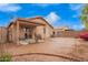 Large backyard with covered patio, desert landscaping, and block fence at 16737 N 157Th Ave, Surprise, AZ 85374