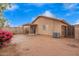 Backyard with stucco wall, patio, lush bougainvillea, and desert plants at 16737 N 157Th Ave, Surprise, AZ 85374