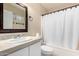 Bright bathroom features a large mirror, updated sink and vanity, tile backsplash, and shower with tub at 16737 N 157Th Ave, Surprise, AZ 85374
