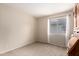 Neutral bedroom features carpet, built-in storage, and natural light from the window with privacy blinds at 16737 N 157Th Ave, Surprise, AZ 85374