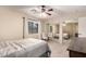 Neutral-toned bedroom featuring carpet, a ceiling fan, mirrored closet doors, and a queen size bed at 16737 N 157Th Ave, Surprise, AZ 85374