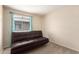 Comfortable bedroom with a dark futon, window with blinds, neutral colored walls, and carpeted floor at 16737 N 157Th Ave, Surprise, AZ 85374