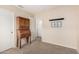 Bedroom with neutral walls, carpet, and furniture hutch with classic design at 16737 N 157Th Ave, Surprise, AZ 85374