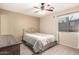 Cozy bedroom with neutral tones, a ceiling fan, carpeted floor, and a comfortable queen-size bed at 16737 N 157Th Ave, Surprise, AZ 85374