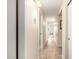 Hallway with tile floor leading to rooms, well-lit with updated fixtures at 16737 N 157Th Ave, Surprise, AZ 85374