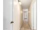 Bright hallway featuring tile flooring, light fixtures, and white doors at 16737 N 157Th Ave, Surprise, AZ 85374