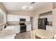 Bright kitchen features white cabinets, stainless steel appliances, and adjacent round table dining area at 16737 N 157Th Ave, Surprise, AZ 85374