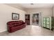 Living area showcasing tile flooring, sliding glass doors, a cabinet and a painting at 16737 N 157Th Ave, Surprise, AZ 85374
