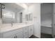 The bathroom features double sinks with chrome fixtures, modern cabinets, and tile flooring at 17310 W Via Dona Rd, Surprise, AZ 85387