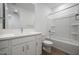 This all-white bathroom features a tub/shower combo, a toilet, and a modern single sink vanity at 17310 W Via Dona Rd, Surprise, AZ 85387