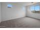 Neutral bedroom with plush carpeting, bright walls, and well-placed windows offering plenty of natural light at 17310 W Via Dona Rd, Surprise, AZ 85387