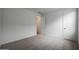This bedroom offers neutral walls and carpet, with a view into the closet, and a paneled door at 17310 W Via Dona Rd, Surprise, AZ 85387