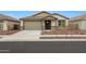 Charming single-story home featuring a neutral palette, two-car garage, and low-maintenance desert landscaping at 17310 W Via Dona Rd, Surprise, AZ 85387