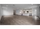 Spacious open floor plan seamlessly connects the living area and kitchen with hardwood-style floors at 17310 W Via Dona Rd, Surprise, AZ 85387