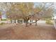 A spacious desert-landscaped backyard is enhanced with a large tree, offering a tranquil outdoor setting at 19835 N Alta Loma Dr, Sun City West, AZ 85375