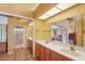 Bright bathroom with double sinks and a mirrored closet door in a yellow-walled setting at 19835 N Alta Loma Dr, Sun City West, AZ 85375