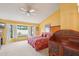 Spacious bedroom with a ceiling fan, yellow walls, carpeting, and a bay window with natural light at 19835 N Alta Loma Dr, Sun City West, AZ 85375