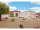 Charming single-story home featuring a red tile roof, low-maintenance landscaping, and an attached two-car garage at 19835 N Alta Loma Dr, Sun City West, AZ 85375