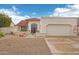 Single-story house featuring a red tile roof, desert landscaping, and an attached two-car garage with walkway at 19835 N Alta Loma Dr, Sun City West, AZ 85375