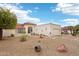 Expansive front exterior showcases xeriscaping, neutral stucco and a beautiful tile roof against a bright blue sky at 19835 N Alta Loma Dr, Sun City West, AZ 85375