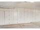 Spacious garage features ample storage cabinets along the back wall, providing plenty of room for organization at 19835 N Alta Loma Dr, Sun City West, AZ 85375
