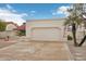 A two-car garage featuring a solid, neutral-colored door, long driveway, and a clear view of the blue sky at 19835 N Alta Loma Dr, Sun City West, AZ 85375