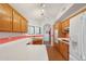 Kitchen with white countertops and appliances, wood cabinets, and a view to breakfast nook at 19835 N Alta Loma Dr, Sun City West, AZ 85375