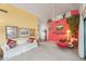 Inviting living room with comfortable furnishings, a yellow accent wall, and views of the entryway at 19835 N Alta Loma Dr, Sun City West, AZ 85375
