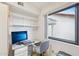 This office features built-in shelving, natural light from the window, and a dedicated workspace with a desk and comfortable chair at 19835 N Alta Loma Dr, Sun City West, AZ 85375