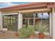 Enjoy the Arizona sunshine on this patio that leads into a sunroom, surrounded by lush desert landscaping at 19835 N Alta Loma Dr, Sun City West, AZ 85375