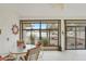 Outdoor living space with tiled floors, large windows, and cozy seating area with views at 19835 N Alta Loma Dr, Sun City West, AZ 85375